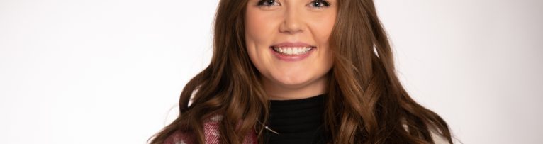 Professional headshot of a confident Madison Wi area businesswoman in business casual attire, projecting competence and approachability.