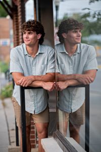 Graham looking thoughtful in urban setting with street art background