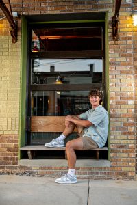 Graham smiling at camera with mix of natural and urban settings in Madison, WI