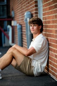 Urban brick wall setting for Graham's senior session on Monroe St.