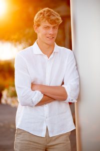 Natural light senior photo with relaxed pose and soft background in Madison WI