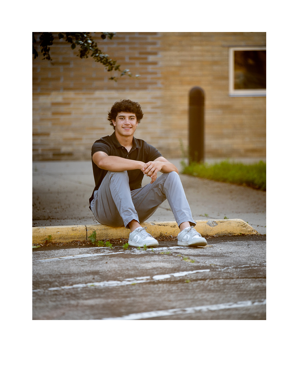 Relaxed senior portrait outdoors in Madison WI natural setting with soft light and greenery